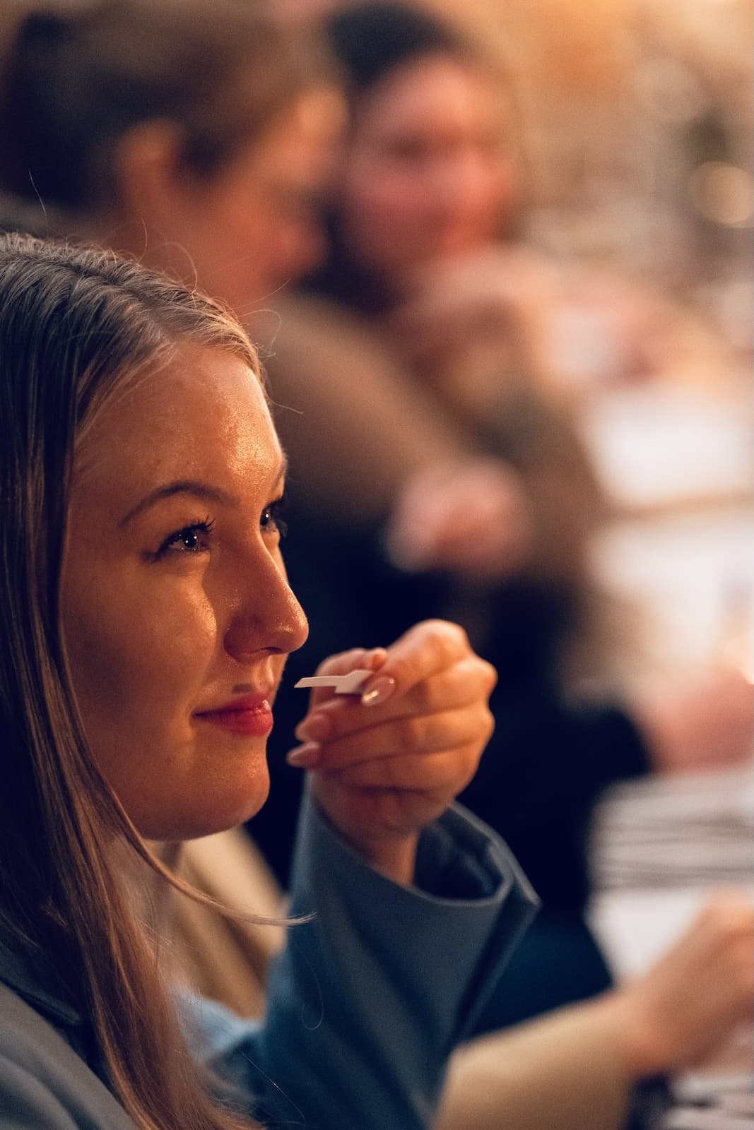A guest smelling a scent strip at a candlelit table