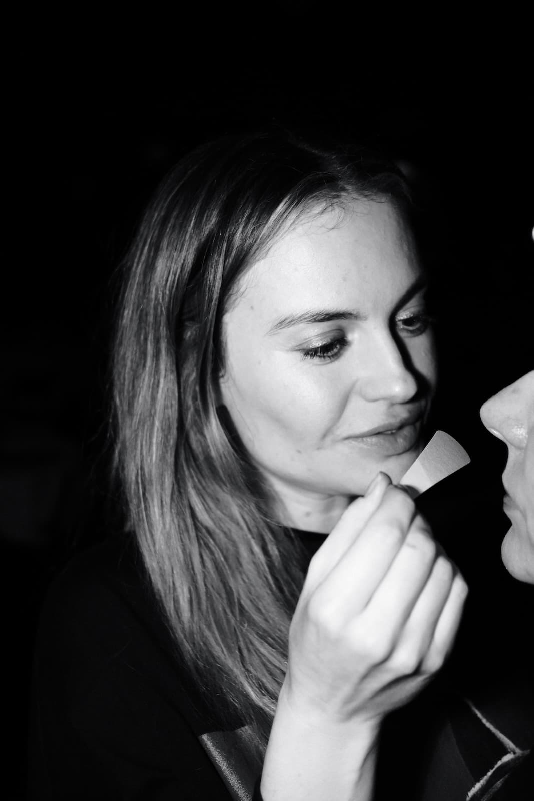 A guest smelling a scent strip held out to her at a club evening